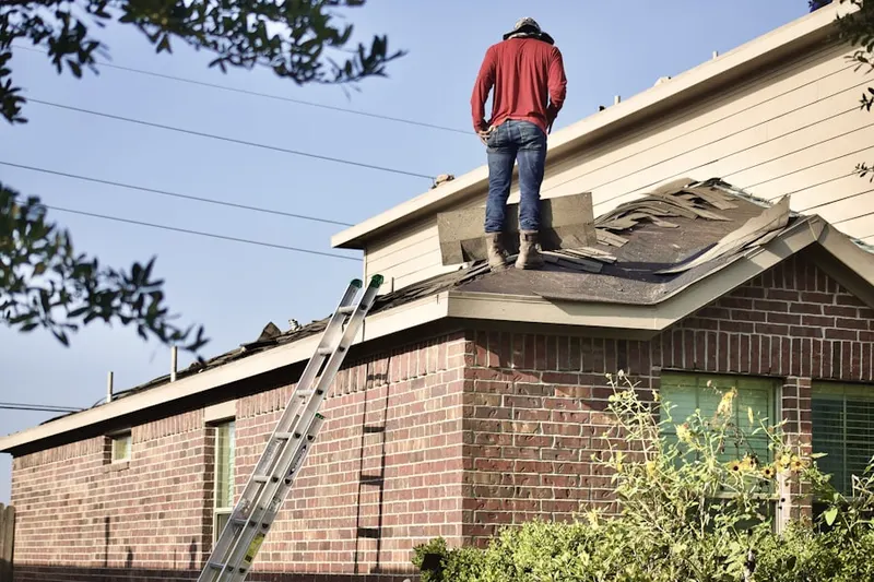 Professional roofer working on a residential roof in Hill Forest Estates